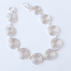 Silver spiral necklace on a white background
