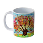 Colourful mug with a tree of life design on a white background