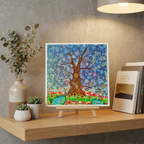 Colourful abstract artwork of a Tree of Life with a Dragonfly on a stand with decorative items on a shelf.