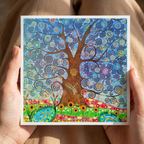 Colourful tree of life design held by hands