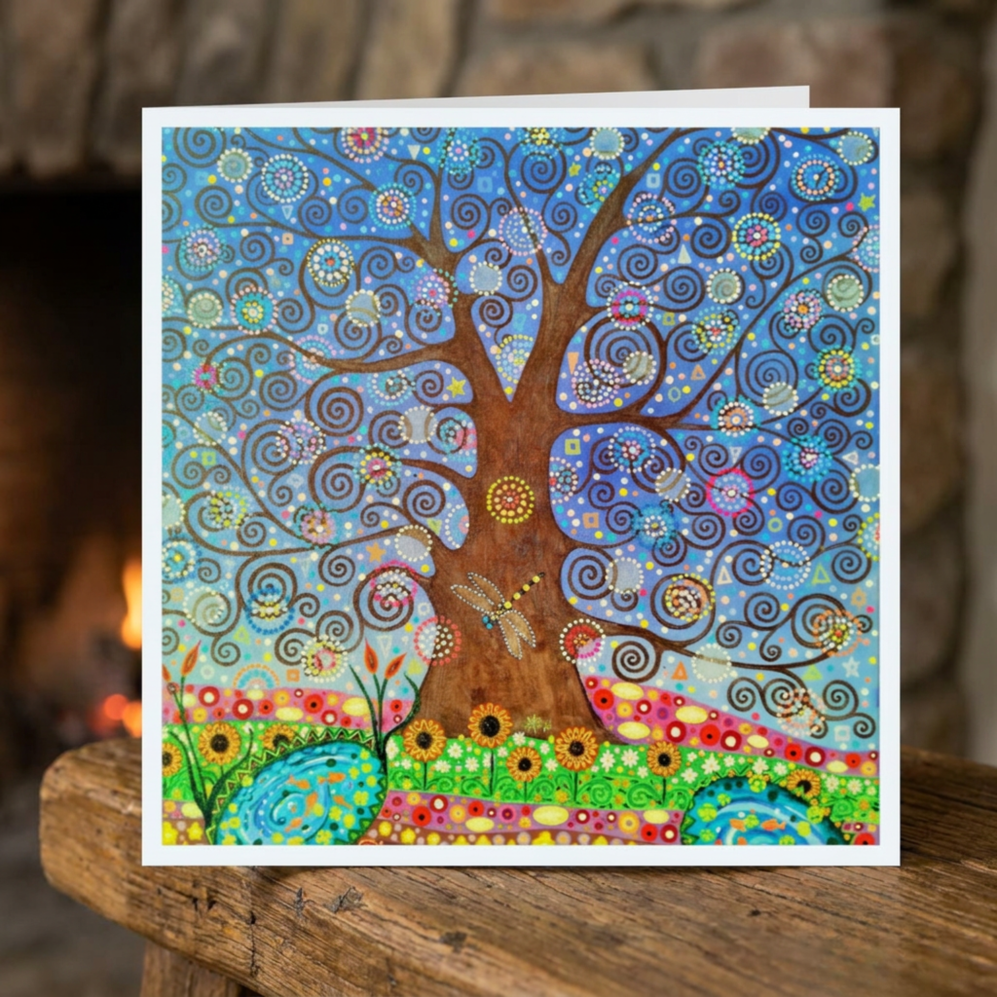Colourful tree design on a greeting card with a blurred background