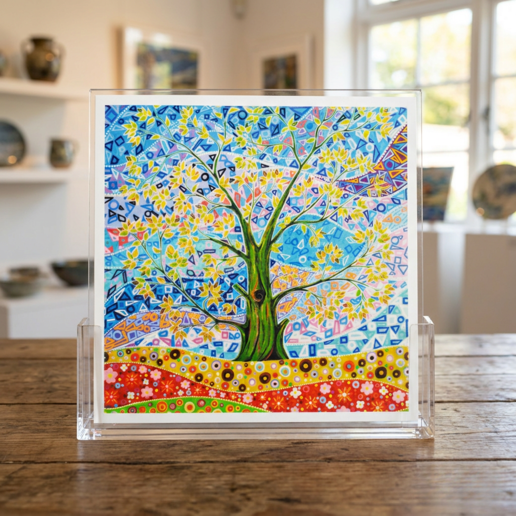 Colourful abstract artwork of a tree of life on a wooden table