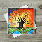Colourful tree of life painting greeting card on a wooden surface