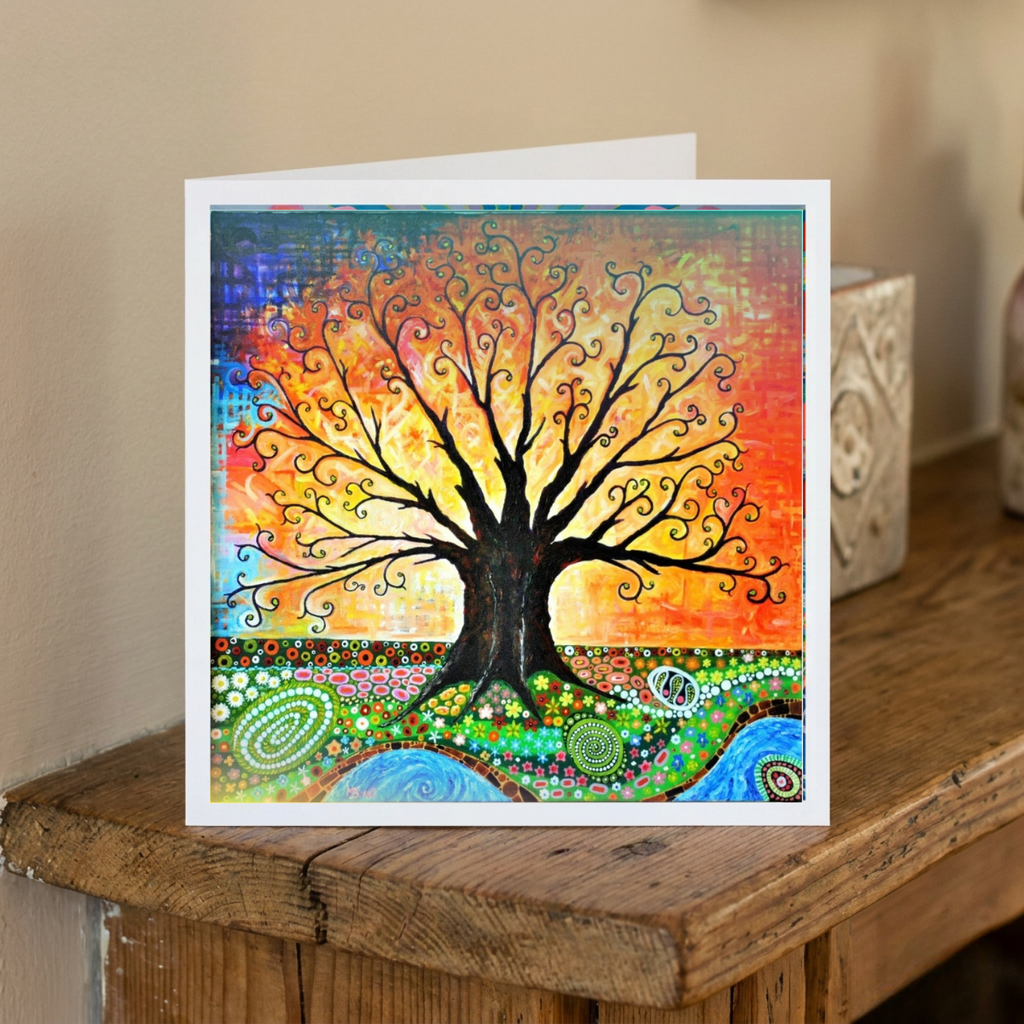 Colourful tree of life card on a wooden surface