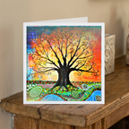 Colourful tree of life card on a wooden surface