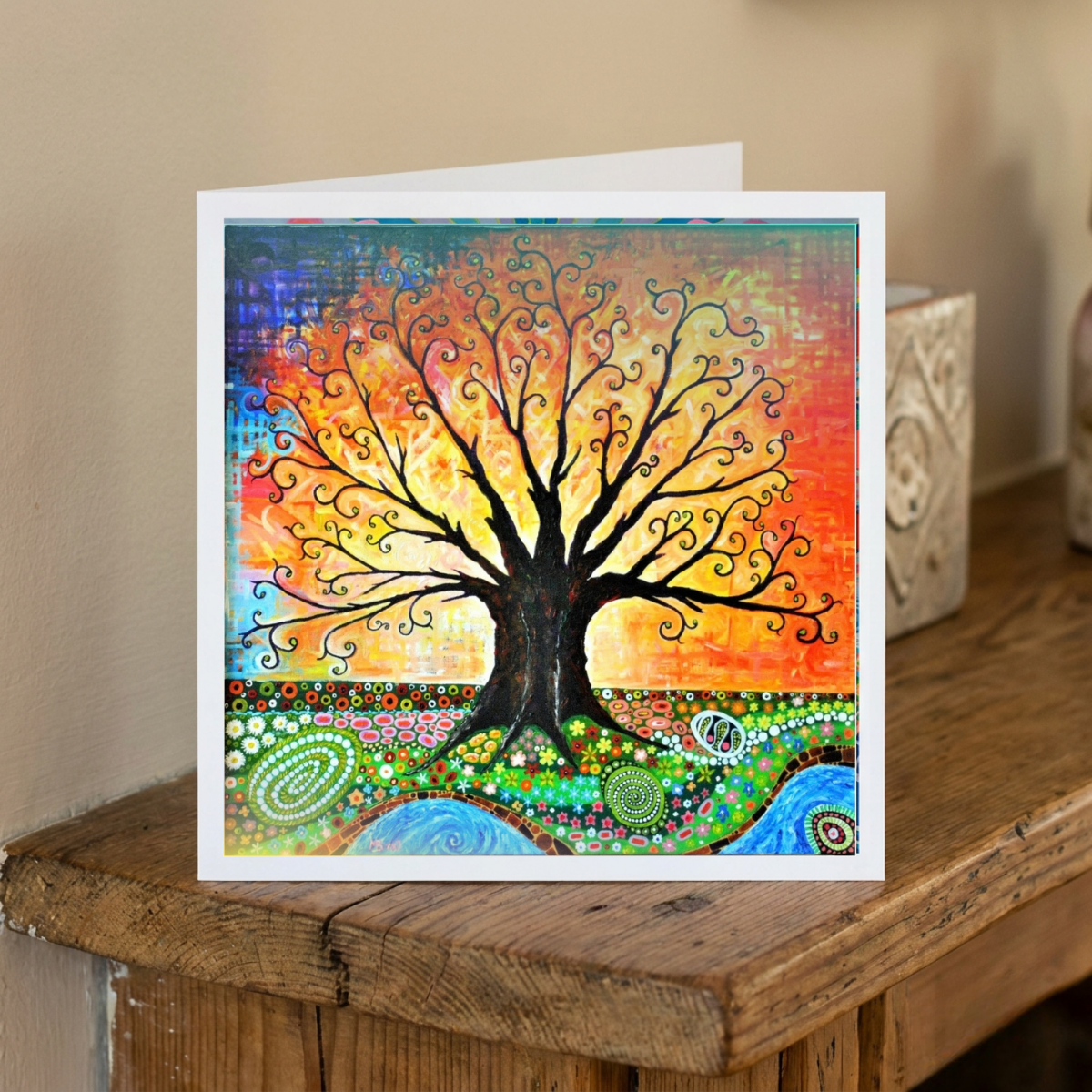 Colourful tree of life card on a wooden surface