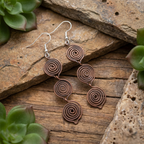 Triple teardrop copper earrings flat lay, handmade boho drop earrings UK