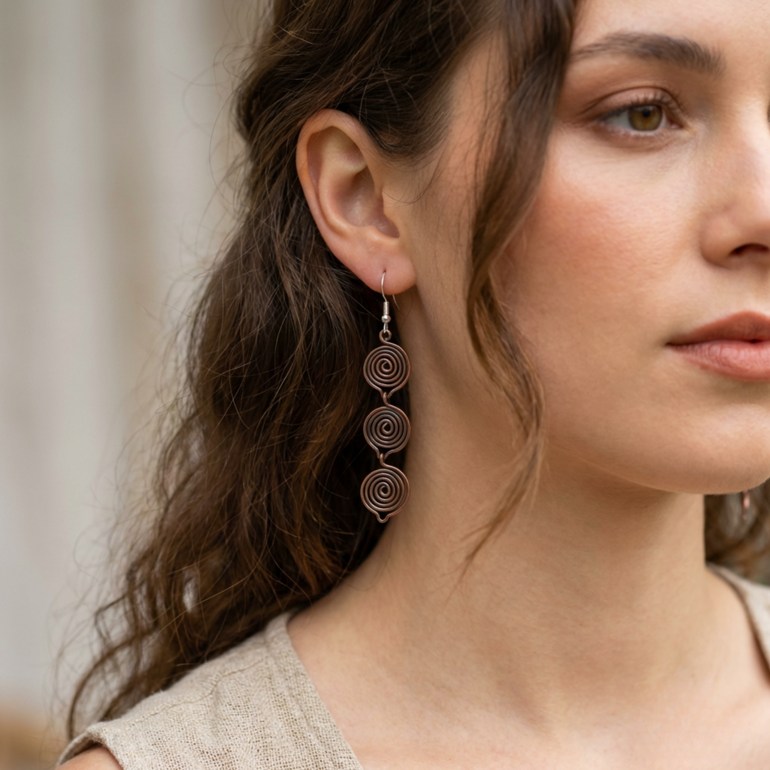 Triple teardrop copper earrings worn by model, handmade boho drop earrings UK