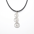 Silver spiral pendant on a black cord against a white background