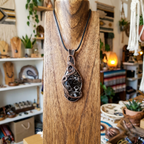 Decorative pendant on a wooden stand in a store setting