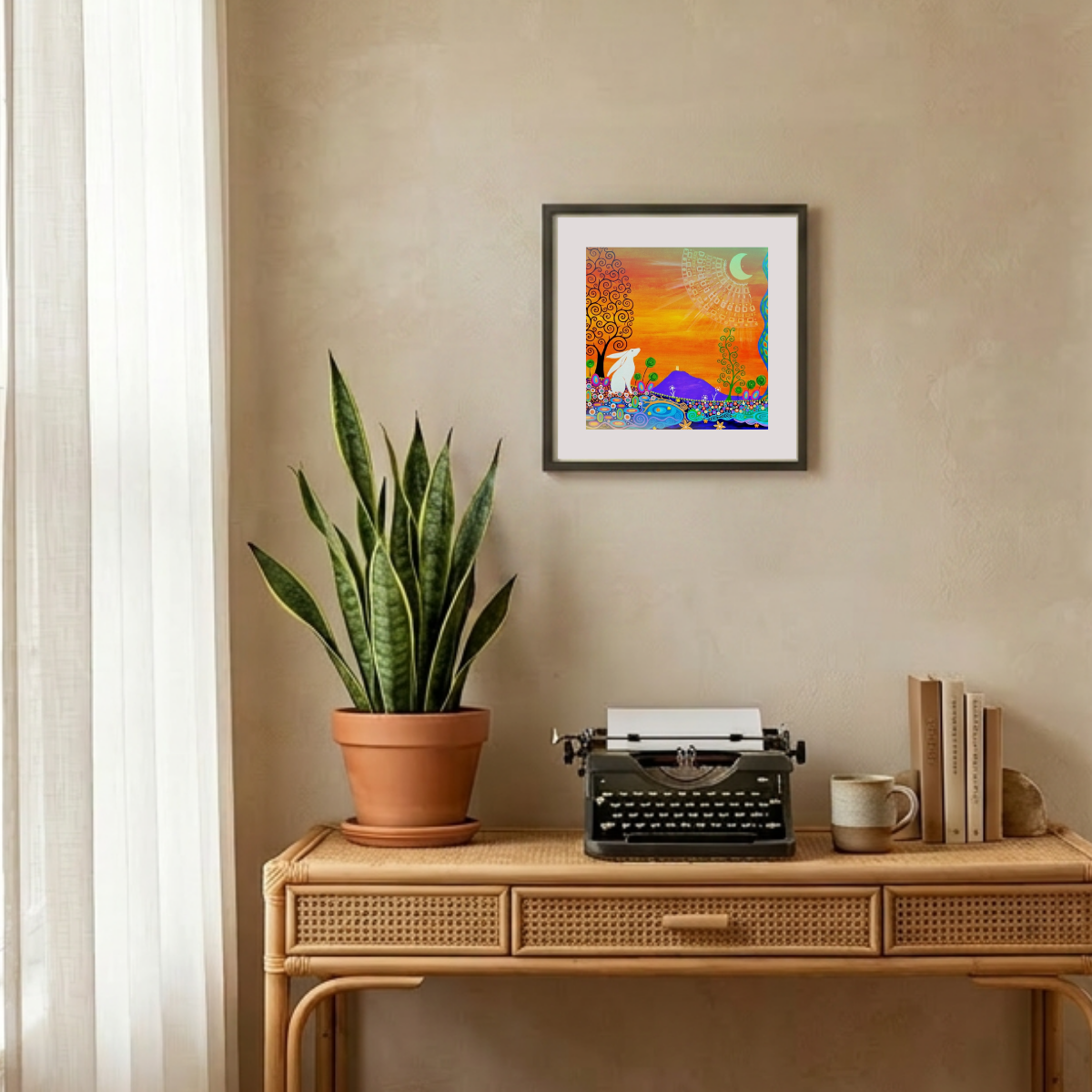 Decorative setup with a potted plant, typewriter, and framed artwork on a wooden console table.