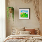 Cozy bedroom with a bed, pillows, and wall art in a home setting.