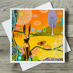 Colourful card with a hare and butterfly design on a wooden surface
