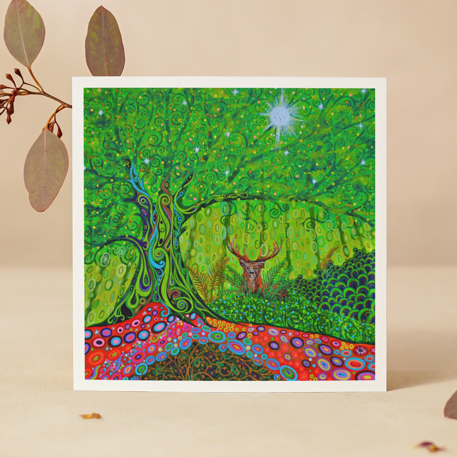Framed artwork of a colourful forest scene with a deer, on a beige background.