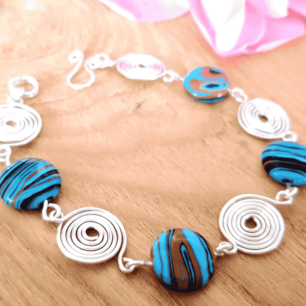 Bracelet with blue and black beaded elements on a wooden surface