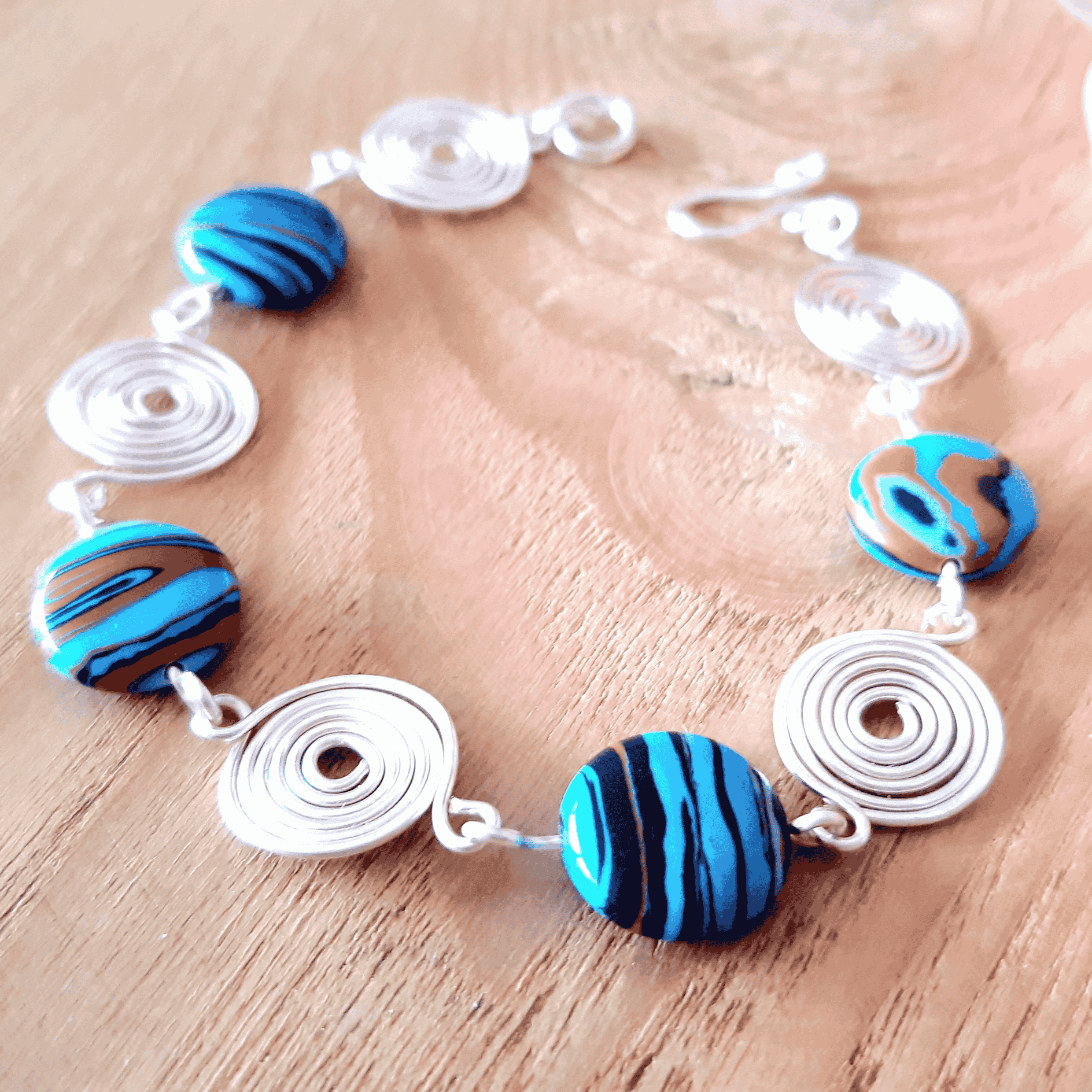 Bracelet with blue and brown beads on a wooden surface