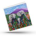 Colorful greeting card with elephants and floral design on a white background