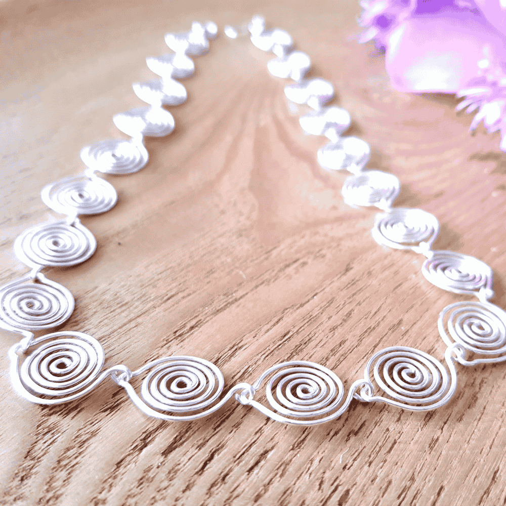 Close up view showing the tead drop spirals n this silver spiral necklace