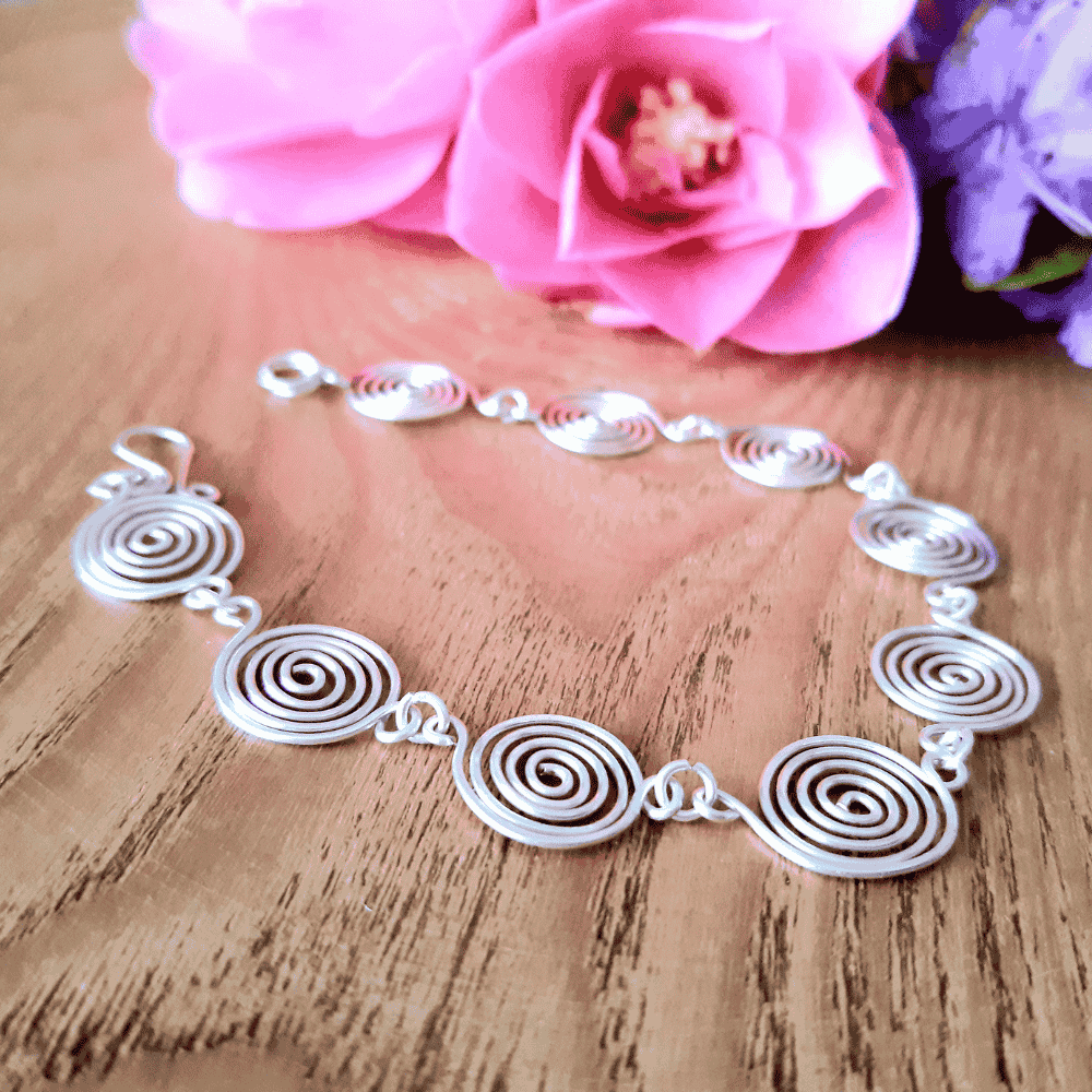 3.	Open silver spiral bracelet flat lay, handmade wire jewellery UK, Wildform