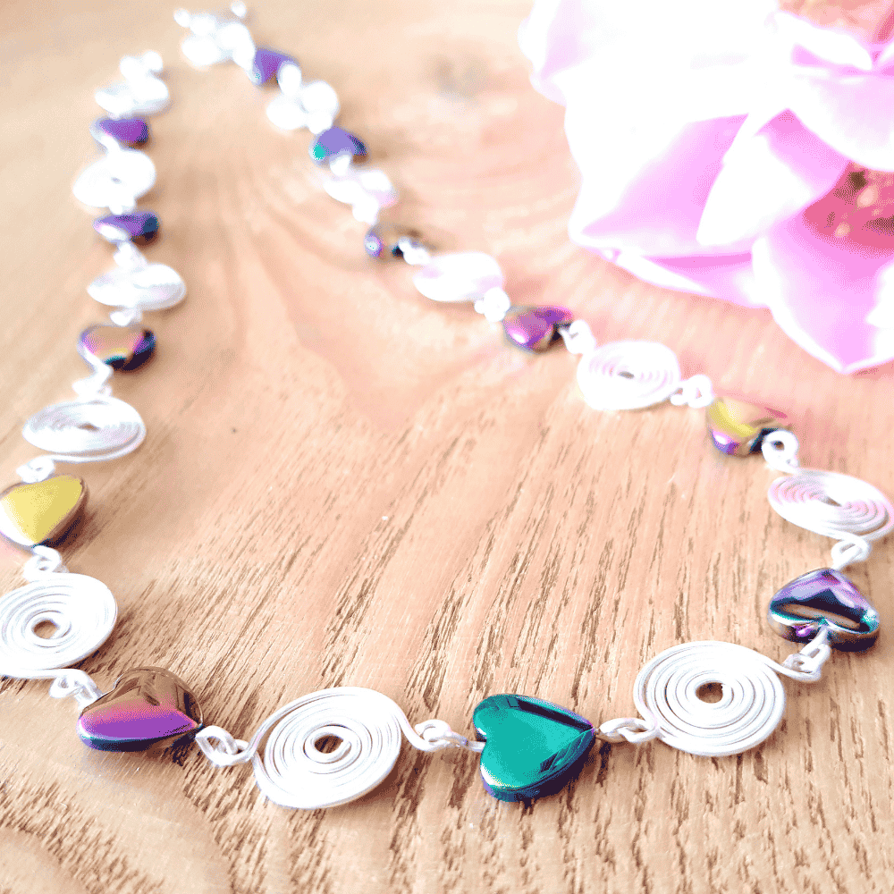 Necklace with heart-shaped and round shapes on a wooden surface