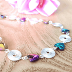 Necklace with colorful heart-shaped beads on a wooden surface